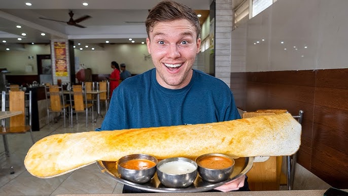 A man holding Dosa